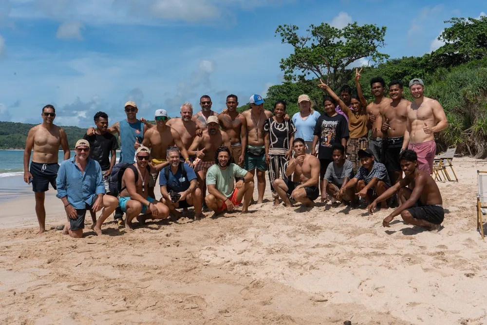 Lawang investors on a site visit, gathered on a beach