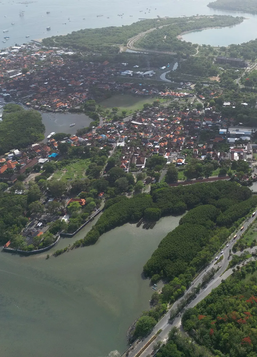 Aerial view of a coastal town with homes, shops and roads
